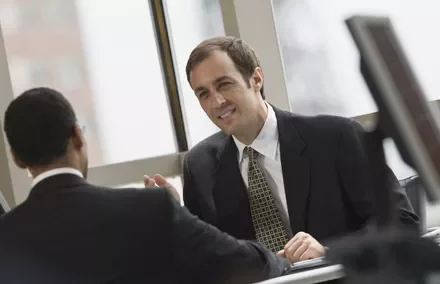 Dos personas en una reunión de trabajo en la oficina.